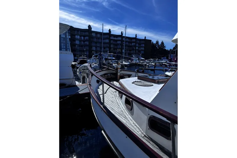 Slide: The Image of 1979 Ocean Alexander 40 Double Cabin yacht docked at marina under blue sky. - 4
