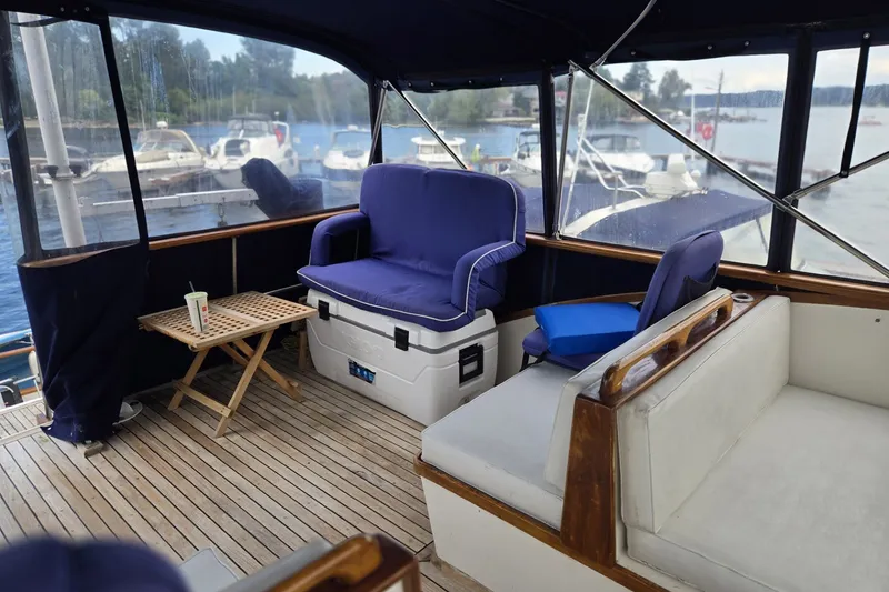 Slide: The Image of 1979 Ocean Alexander 40 Double Cabin interior with blue seating and wooden accents. - 60