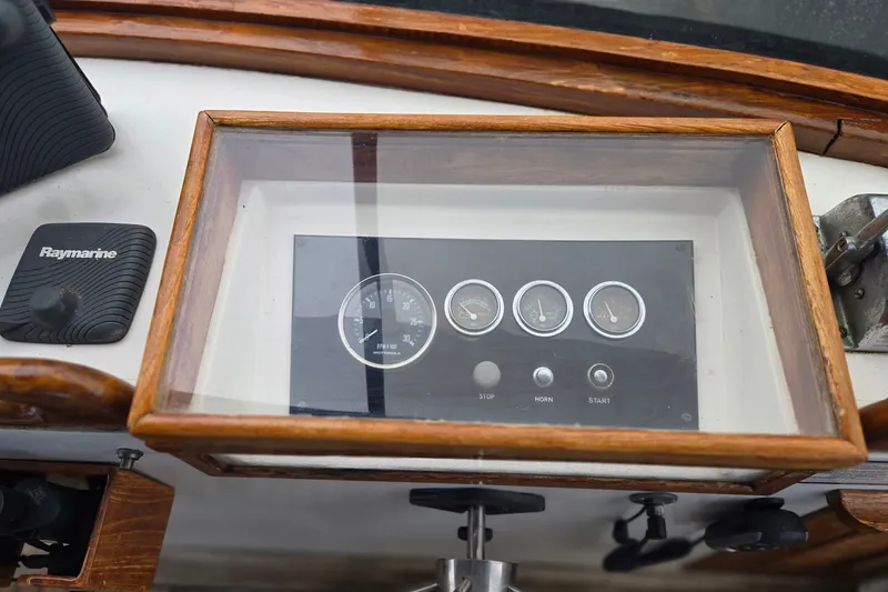 Slide: The Image of 1979 Ocean Alexander 40 Double Cabin dashboard with gauges and Raymarine control. - 63