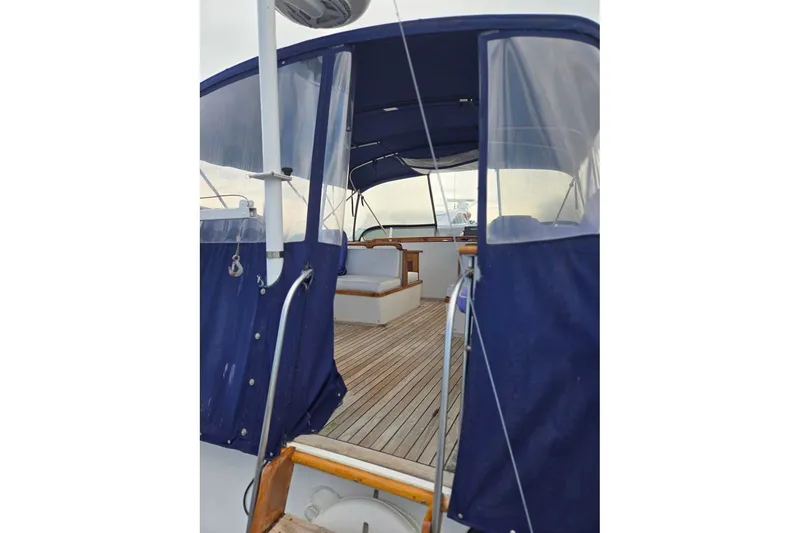 Slide: The Image of 1979 Ocean Alexander 40 Double Cabin yacht with blue canopy and wooden deck. - 59