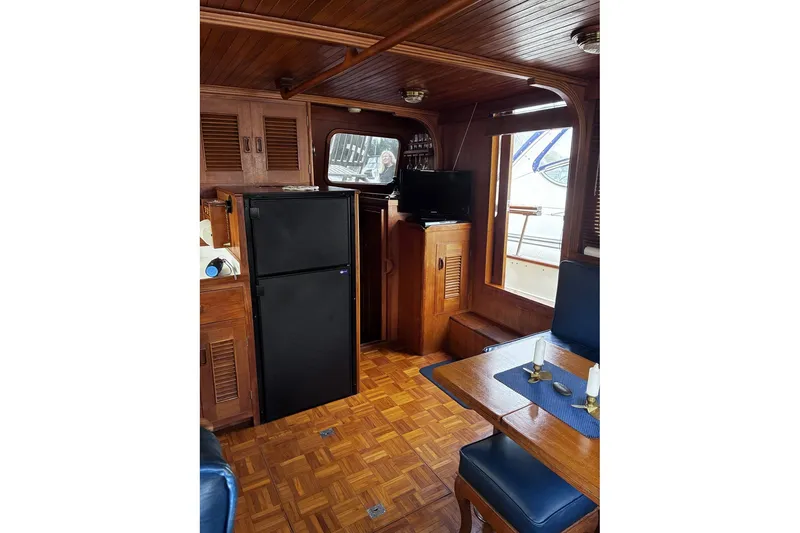 Slide: The Image of Interior of 1979 Ocean Alexander 40 Double Cabin with wood paneling and dining area. - 16