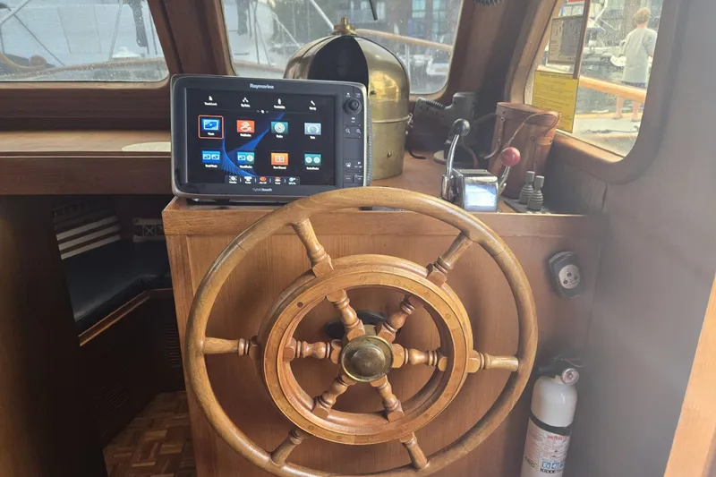 Slide: The Image of 1979 Ocean Alexander 40 Double Cabin helm with wooden wheel and navigation display. - 20