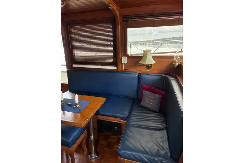 Slide: The Image of Interior of 1979 Ocean Alexander 40 Double Cabin with blue seating and wooden accents. - 14