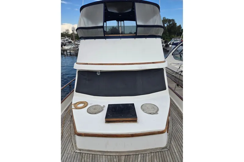 Slide: The Image of 1979 Ocean Alexander 40 Double Cabin yacht docked at marina, front view. - 8