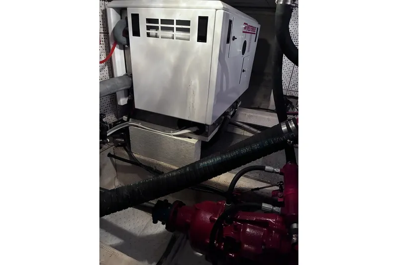 Slide: The Image of Engine room of 1979 Ocean Alexander 40 Double Cabin with generator and hoses. - 48