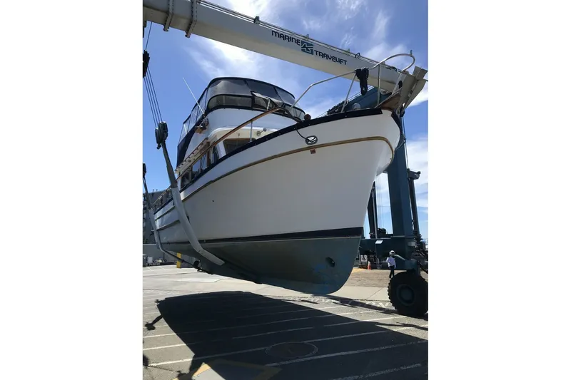 Slide: The Image of 1979 Ocean Alexander 40 Double Cabin yacht lifted by a marine travelift. - 68