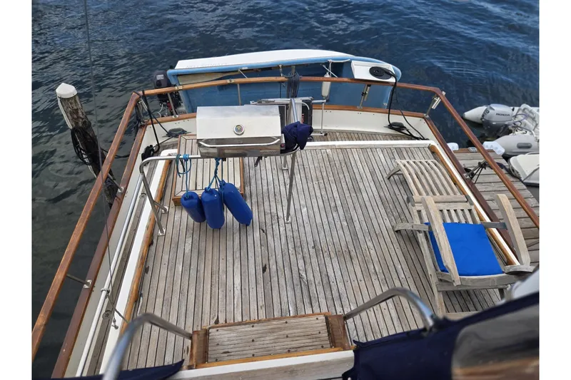 Slide: The Image of 1979 Ocean Alexander 40 Double Cabin yacht deck with wooden flooring and blue seating. - 65