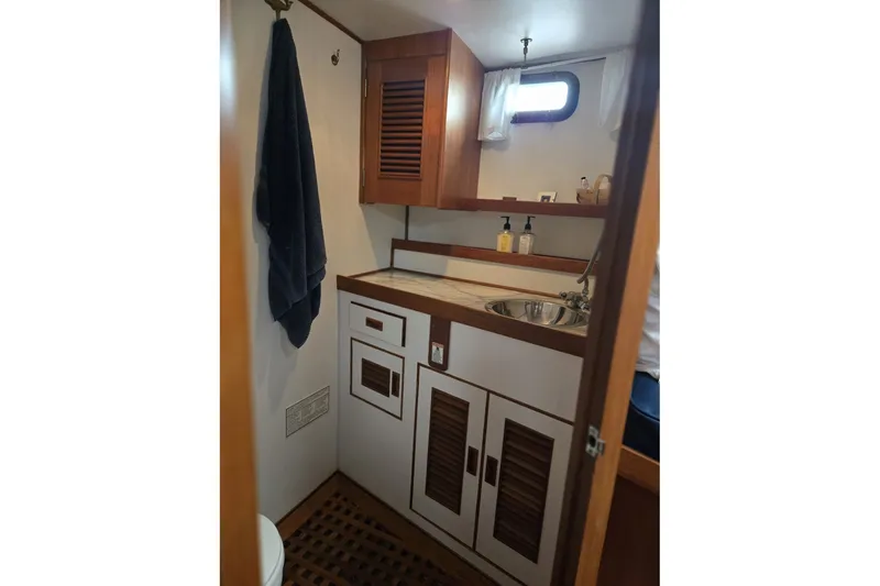 Slide: The Image of 1979 Ocean Alexander 40 Double Cabin bathroom with wooden cabinets and stainless steel sink. - 44