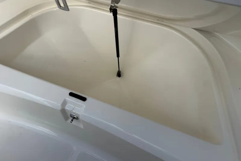 Slide: The Image of Open storage compartment on a 2000 Boston Whaler 21 Outrage boat. - 14