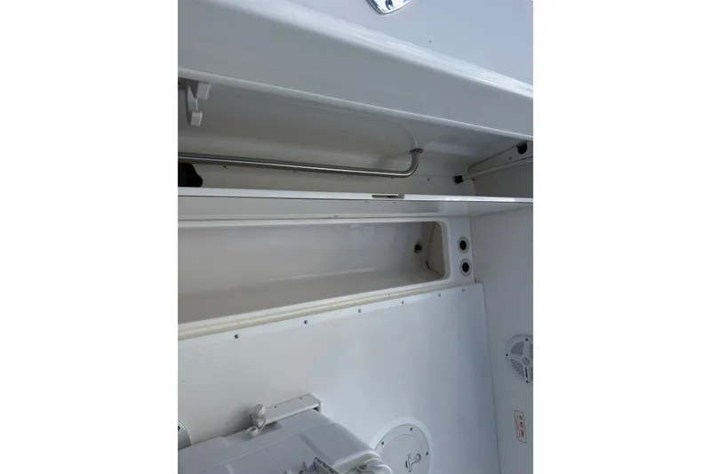Slide: The Image of Interior view of a 2000 Boston Whaler 21 Outrage boat, showcasing storage compartment. - 15