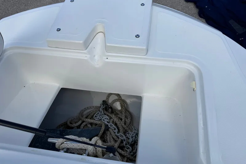 Slide: The Image of Anchor storage compartment on a 2000 Boston Whaler 21 Outrage boat. - 13