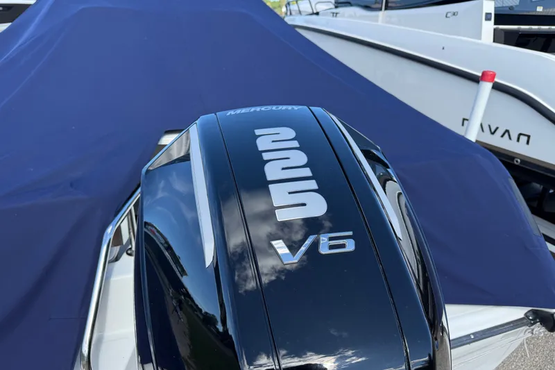 Slide: The Image of Mercury V6 engine on a 2000 Boston Whaler 21 Outrage boat, covered with a blue tarp. - 21