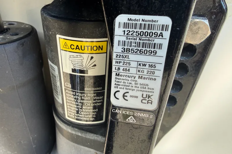 Slide: The Image of Caution label and Mercury Marine engine specifications on Boston Whaler 21 Outrage, 2000 model. - 20