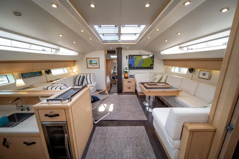 Slide: The Image of Luxurious interior of a 2016 Jeanneau 64 yacht with modern furnishings and ample natural light. - 23