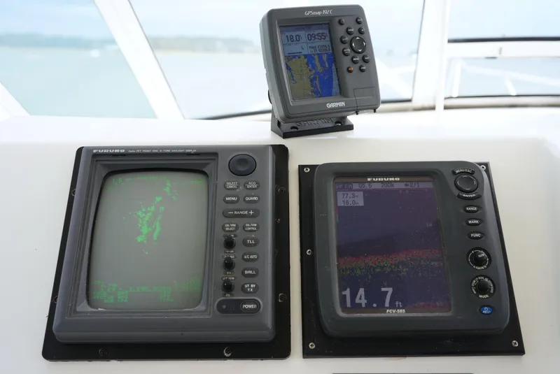 Slide: The Image of The image shows navigation and fish finder screens on a boat. - 16