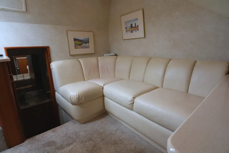 Slide: The Image of Interior of a 1999 Ocean Yachts 40 Super Sport with beige leather couch and carpeted floor. - 23