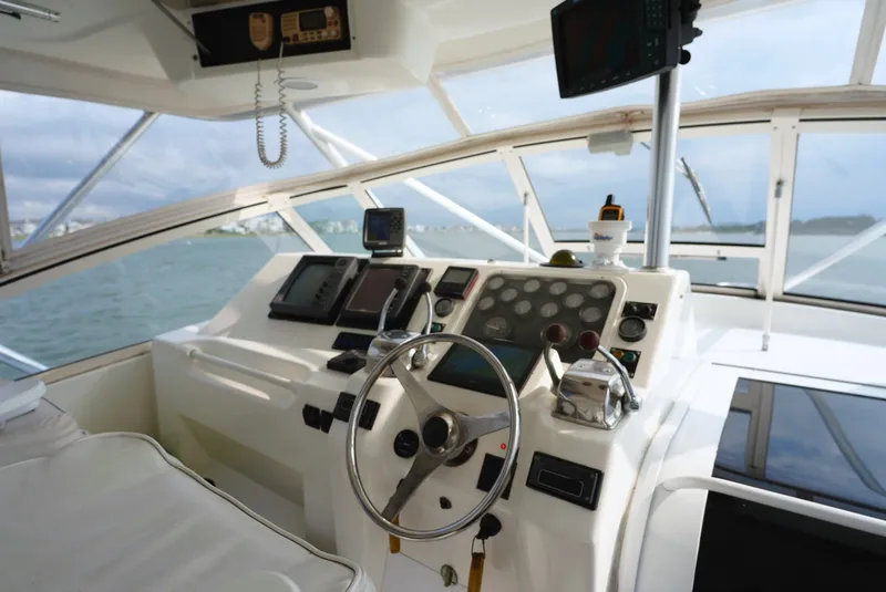 Slide: The Image of The cockpit of a 1999 Ocean Yachts 40 Super Sport with steering wheel, instruments, and electronics. - 15