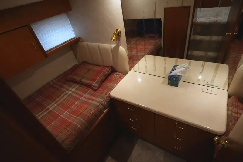 Slide: The Image of Cabin with bed, cabinet, and mirror in a 1999 Ocean Yachts 40 Super Sport. - 24