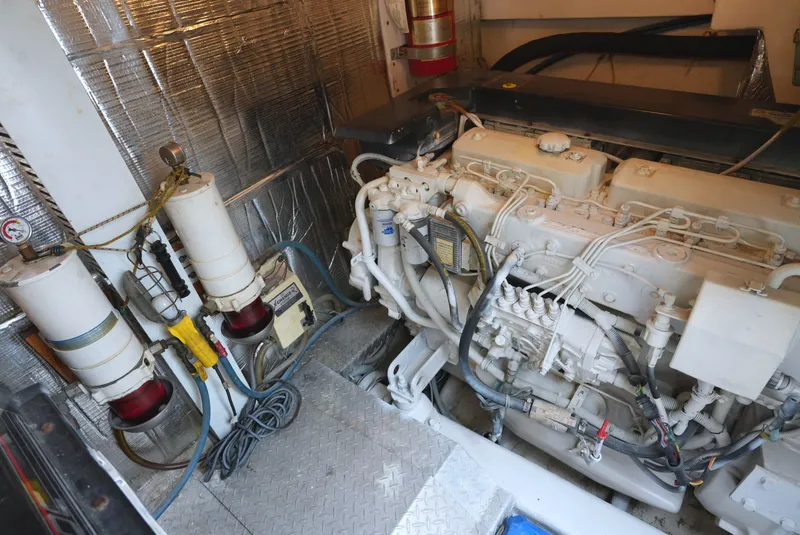 Slide: The Image of Engine room of the 1999 Ocean Yachts 40 Super Sport with a large engine and filters. - 29