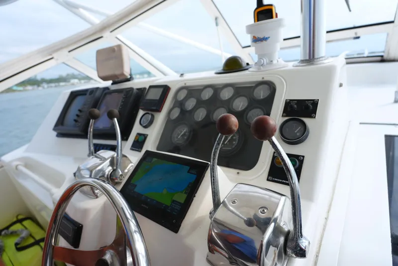 Slide: The Image of The image shows the helm of a 1999 Ocean Yachts 40 Super Sport with modern instruments. - 17