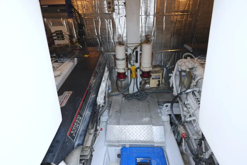 Slide: The Image of Engine room of the 1999 Ocean Yachts 40 Super Sport with two large engines and technical equipment. - 28