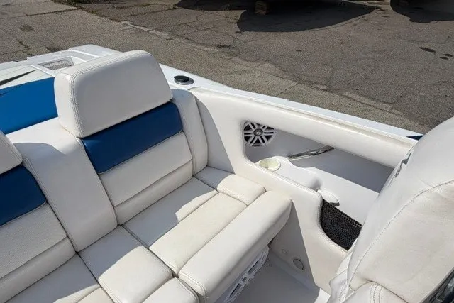 Slide: The Image of 2008 Donzi 27 ZR boat interior with white and blue seating, cup holder, and speaker. - 10
