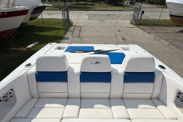 Slide: The Image of 2008 Donzi 27 ZR boat interior with white and blue seating, docked outdoors. - 8