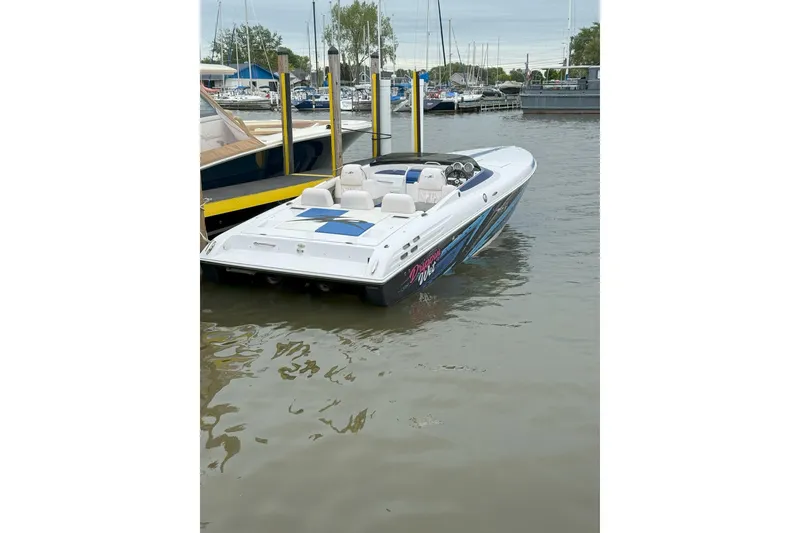 Slide: The Image of 2008 Donzi 27 ZR speedboat docked at a marina, featuring sleek design and vibrant graphics. - 21