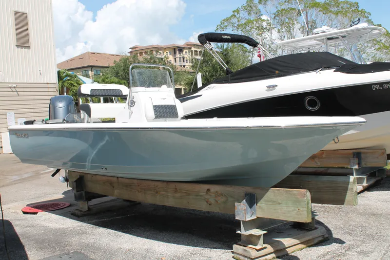 Slide: The Image of 2026 Tidewater 1910 Bay Max boat displayed on wooden supports outdoors. - 2