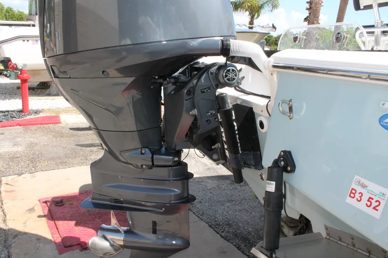 Slide: The Image of Outboard motor on a 2026 Tidewater 1910 Bay Max boat, parked outdoors. - 6