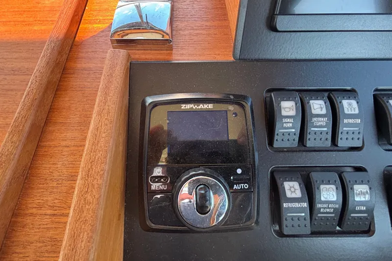Slide: The Image of Control panel of a 2024 Targa 32 boat featuring Zipwake system and switches. - 41