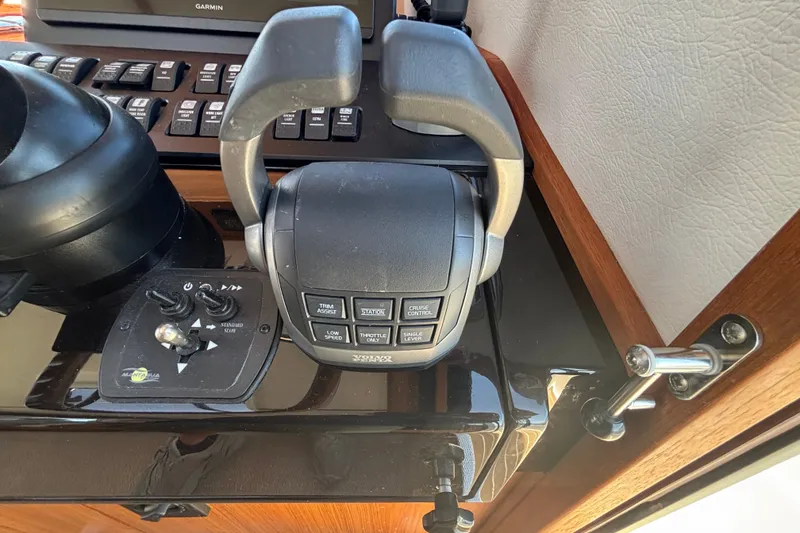 Slide: The Image of Control panel of a 2024 Targa 32 boat with throttle and navigation controls. - 39