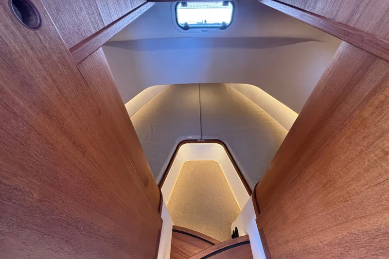 Slide: The Image of Interior view of 2024 Targa 32 yacht cabin with wooden finish and ambient lighting. - 44