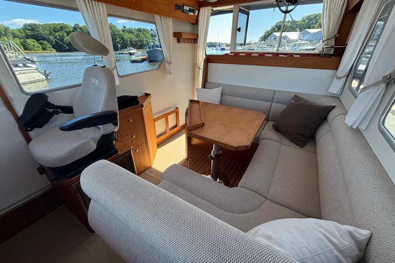 Slide: The Image of Interior of 2024 Targa 32 boat with cozy seating and scenic window views. - 26