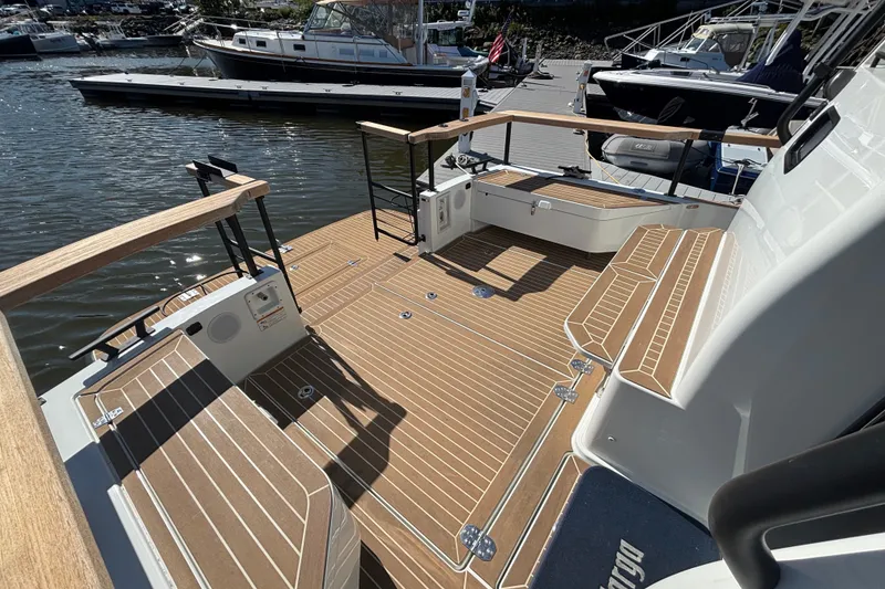 Slide: The Image of 2024 Targa 32 boat deck with wood finish, docked at marina. - 58