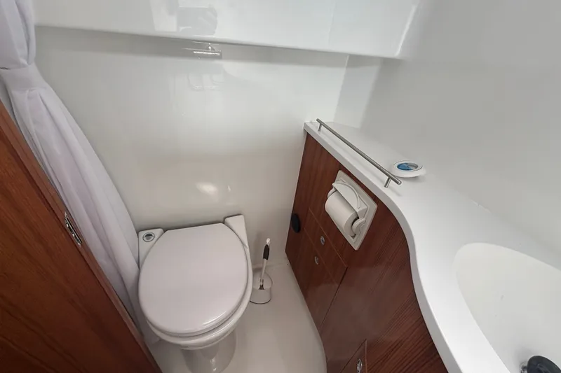 Slide: The Image of 2024 Targa 32 yacht bathroom with modern fixtures and wooden cabinetry. - 46