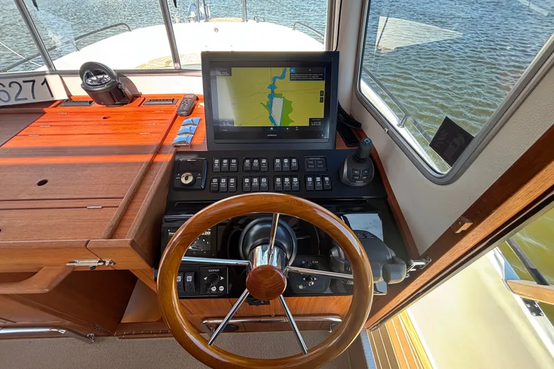 Slide: The Image of Helm of 2024 Targa 32 boat with navigation system and wooden steering wheel. - 37