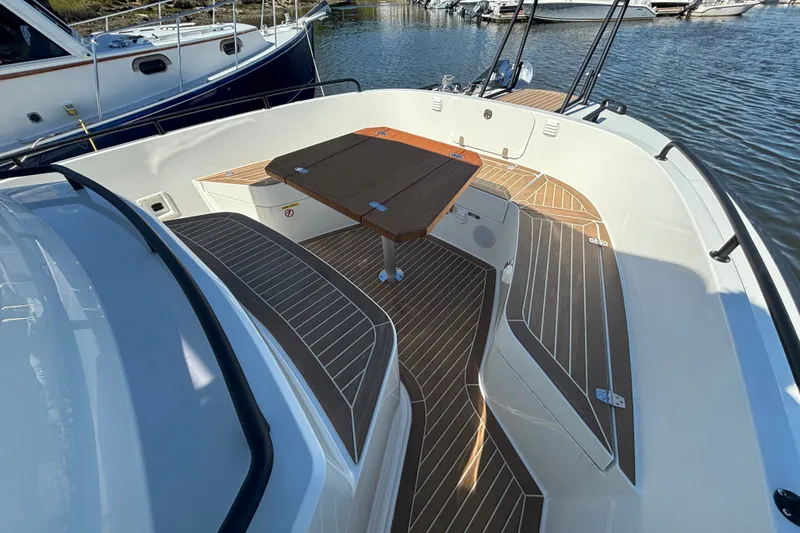 Slide: The Image of 2024 Targa 32 boat deck with wooden table, docked in marina. - 21