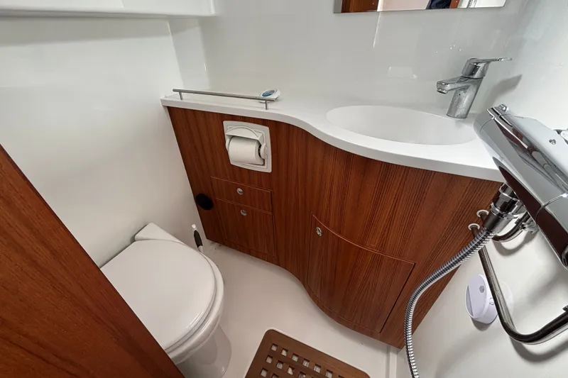 Slide: The Image of Compact bathroom in 2024 Targa 32 boat with wooden cabinetry and modern fixtures. - 47