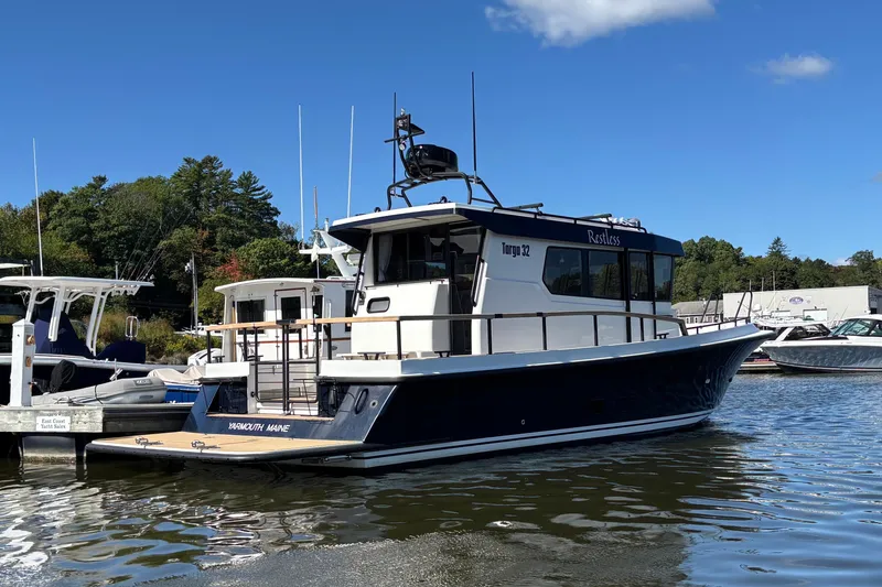 Slide: The Image of 2024 Targa 32 boat docked at marina under clear blue sky. - 8