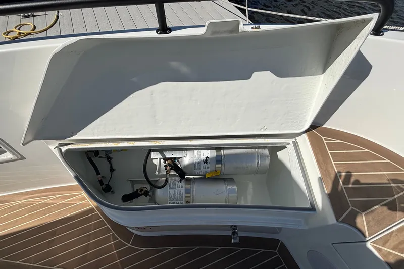 Slide: The Image of Open storage compartment on 2024 Targa 32 boat deck with gas cylinders inside. - 54