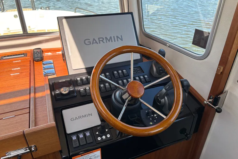Slide: The Image of Helm of 2024 Targa 32 boat with Garmin navigation system and wooden steering wheel. - 36