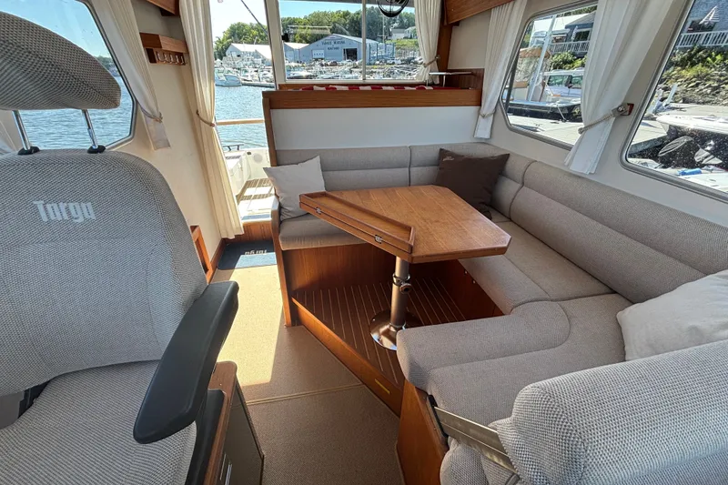 Slide: The Image of Interior of 2024 Targa 32 boat with cozy seating and wooden table. - 25