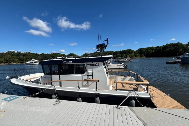 Slide: The Image of 2024 Targa 32 boat docked on a sunny day with clear blue skies. - 11
