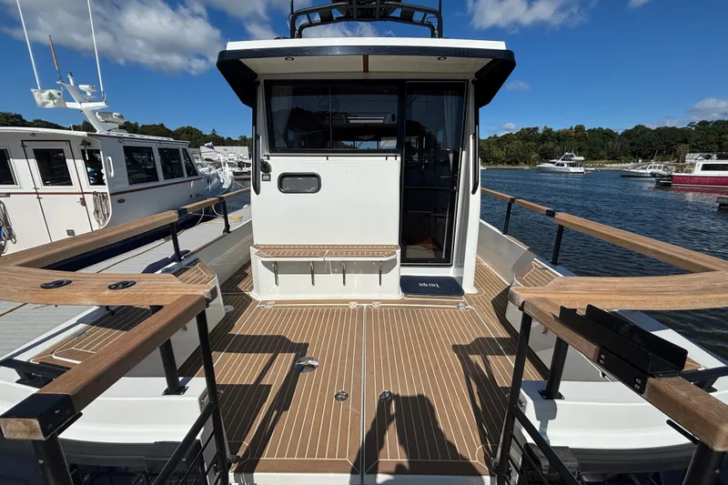 Slide: The Image of 2024 Targa 32 boat deck with wooden railings and open cabin door. - 59
