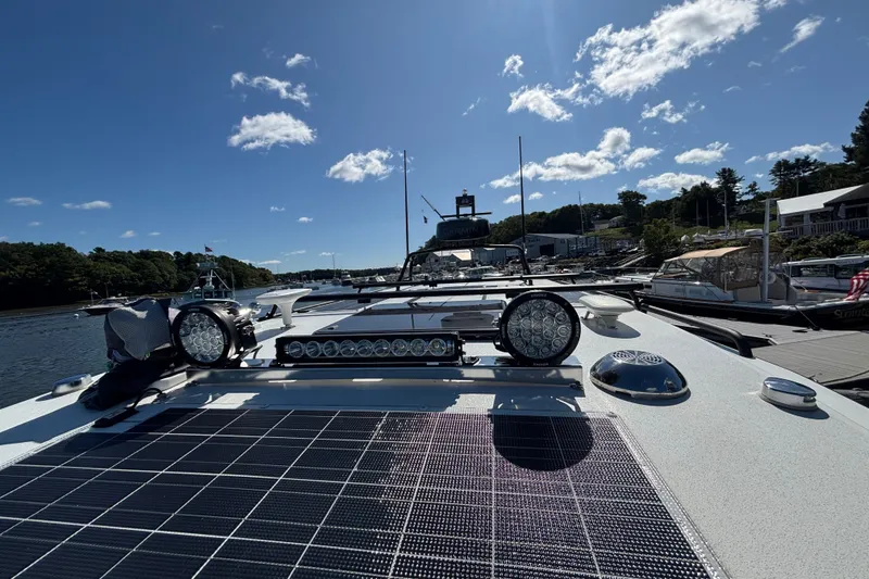 Slide: The Image of 2024 Targa 32 boat with solar panels and lights docked under a clear sky. - 68