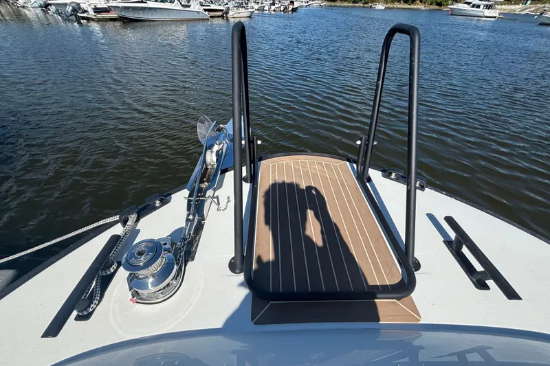 Slide: The Image of Bow view of 2024 Targa 32 boat with anchor and railing on calm water. - 20