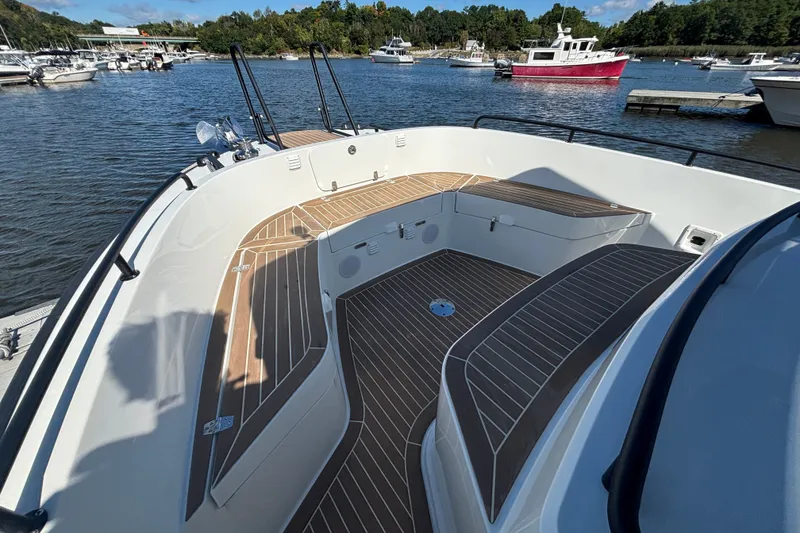 Slide: The Image of 2024 Targa 32 boat deck with wood finish, docked in a marina. - 17