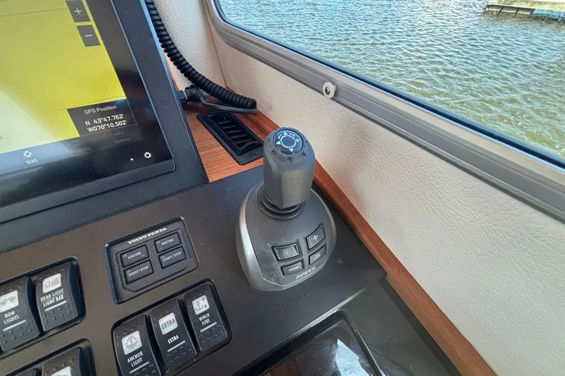 Slide: The Image of Control panel of 2024 Targa 32 boat with joystick and GPS display. - 40
