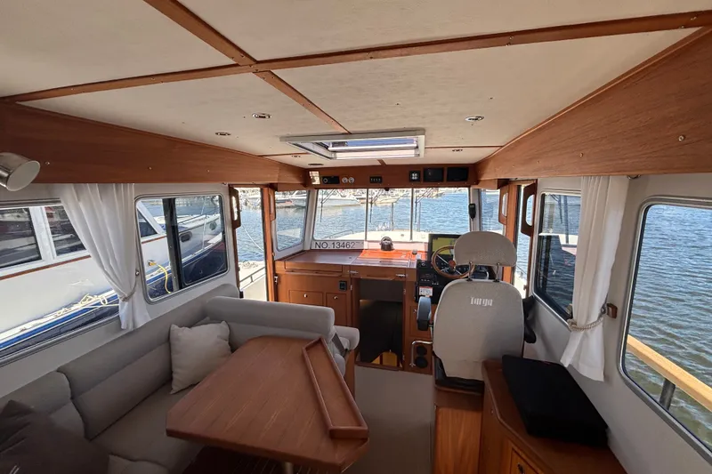 Slide: The Image of Interior of 2024 Targa 32 boat with helm, seating, and wooden accents. - 24